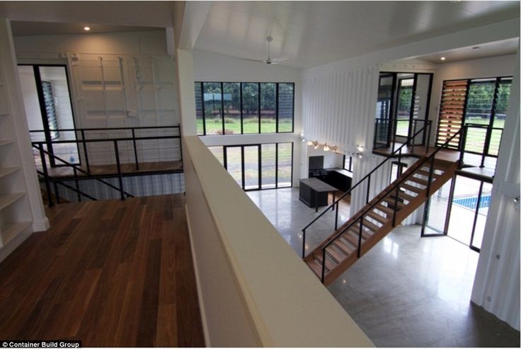 an open floor plan with stairs leading up to the second story and another room in the background