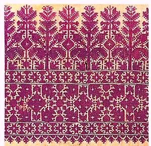 a red and white rug with an intricate design on it