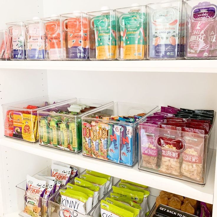 the shelves are filled with snacks and other items for sale in plastic containers on them