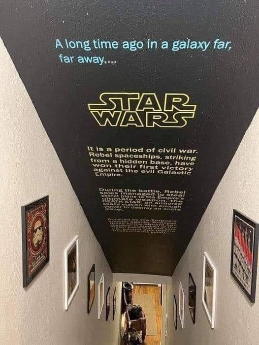 a hallway with star wars posters on the wall and pictures on the ceiling above it