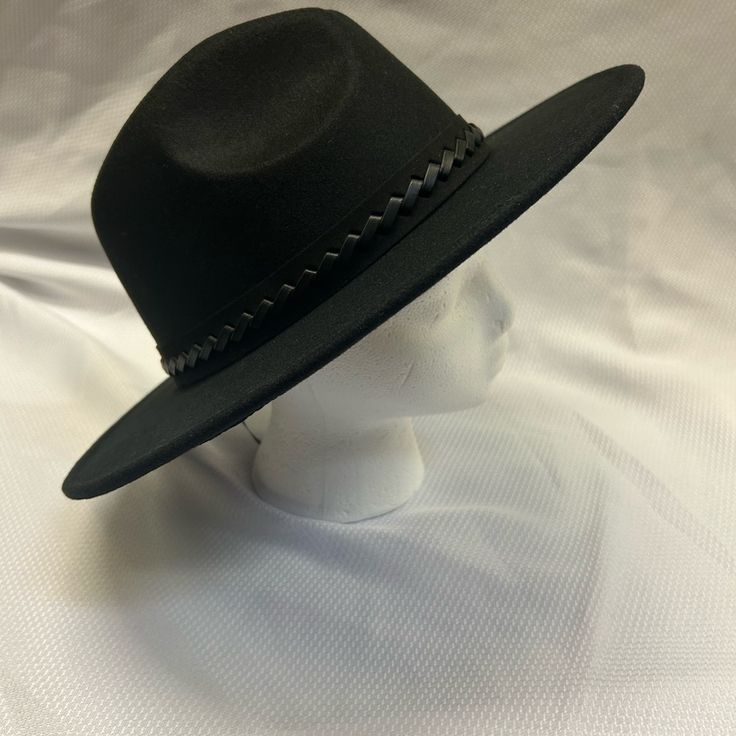 Brand New, Never Been Used. Black Hat Decorated With Woven Leather Strapping. Adjustable Strings Inside For The Perfect Fit. Black Western Fedora With Flat Brim, Adjustable Black Flat Brim Fedora, Classic Black Fedora (one Size Fits Most), Classic Black Fedora One Size Fits Most, Classic Black Fedora One Size, Black Casual Fedora For Spring, Casual Black Fedora For Spring, Adjustable Black Hat Band For Spring, Adjustable Black Hat Bands For Spring