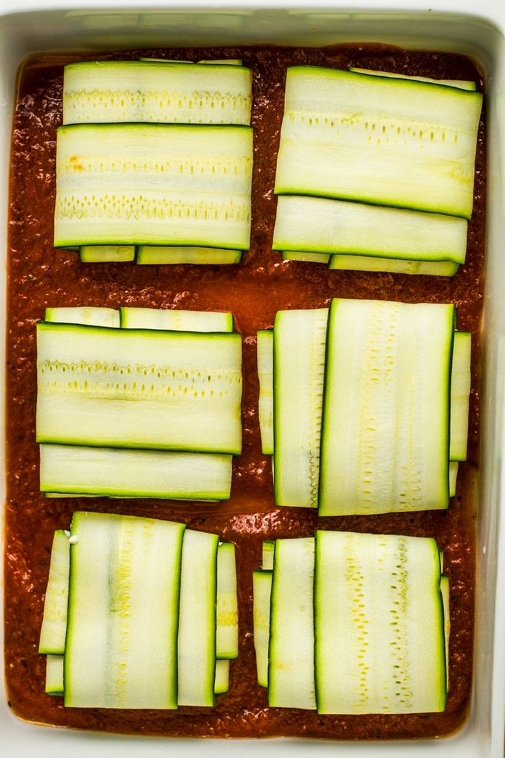 sliced cucumbers in a white dish on a table