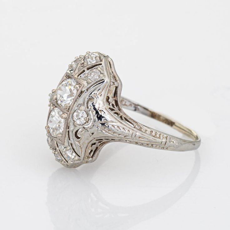 Elegant & finely detailed Belais Art Deco era ring (circa 1920s to 1930s) crafted in 14k white gold.   Two centrally mounted old European cut diamonds are estimated at 0.48 carats each. A further 8 old mine cut diamonds total an estimated 0.42 carats. The total diamond weight is estimated at 1.38 carats (I-J colour and VS2-I2 clarity).      Belais Brothers is a highly regarded and very collectible maker from the late 19th century to the early 20th century. The ring epitomises vintage charm and w Antique Engagement Rings Vintage 1920s Pearl, 1920 Engagement Ring Vintage, Antique Brilliant Cut Diamond White Ring, Antique Brilliant Cut Diamond White Diamond Ring, Antique Diamond White Diamond Ring With Brilliant Cut, Antique Platinum Diamond Ring With Diamond Accents, Victorian Diamond Ring In White Gold, Victorian White Gold Diamond Ring, Classic Collectible Diamond Ring With Center Stone