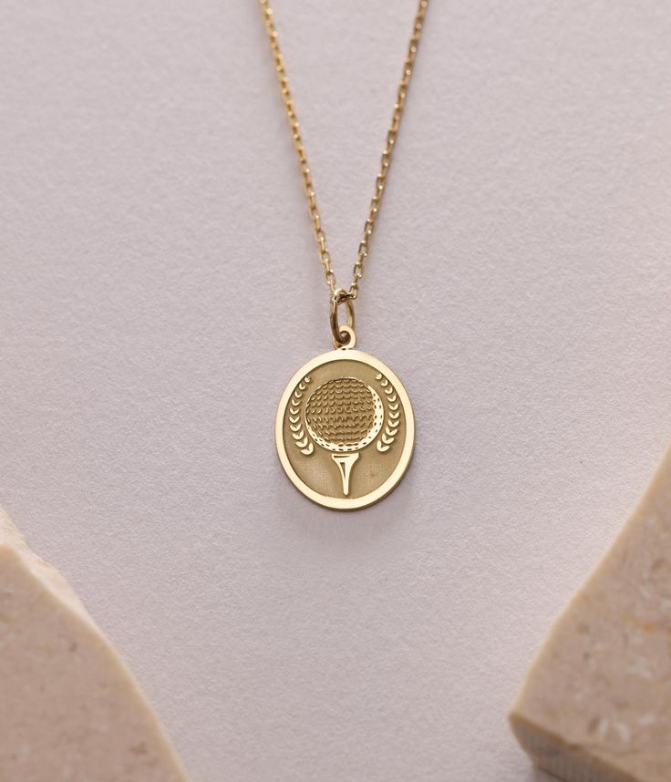 Gold Tennis Ball Pendant - Tennis Ball 14K Gold Necklace ● Material of pendant: Solid Gold 14k ( REAL GOLD ) ● Metal Stamp: 14k ( REAL GOLD ) ● The pendant is available in 5sizes: - 12x17 mm / 0,47 x 0,66 inches - 13x18 mm / 0,51 x 0,70 inches  In the photos - 14x19 mm / 0,55 x 0,74 inches  - 16x21 mm / 0,62 x 0,82 inches  - 18x24 mm / 0,70 x 0,94 inches ( In the photos the size is 13x18 mm / 0,51 x 0,70 inches ) ( Jump Ring inner diameter: 4 mm ) ● Material of chain: Solid gold 14k ( REAL GOLD ) It is thin and dainty and it is available in 4 sizes: - 40 cm / 15,75 inches ( Length ) - 45 cm / 17,72 inches ( Length ) In the photos - 50 cm / 19,68 inches ( Length ) - 55 cm / 21,65 inches ( Length ) ● Backside engraving is FREE ( Please use the personalization box for that.) ● If you want lar White Gold Charm Necklace With Coin Pendant As Gift, White Gold Coin Pendant Charm Necklace As Gift, White Gold Coin Pendant Charm Necklace For Gift, Pendant Necklace For Birthday Gift, Mother’s Day Gift Necklace With Coin Pendant, Oval Charms Necklace For Gift, Classic Engraved Necklace For Birthday Gift, White Gold Necklaces With Charms As A Gift, White Gold Necklaces With Charms For Gift