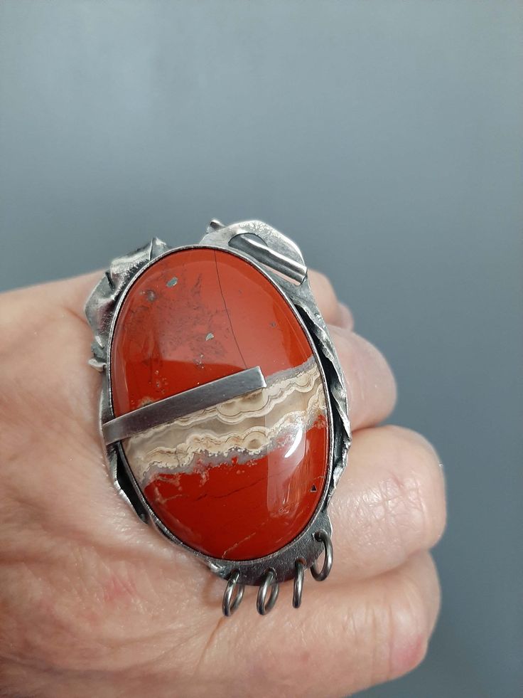 "Lovely hand made oxidized sterling silver + banded agate stone fantasy ring.  You will get this ring. Banded agate is a unique variety of chalcedony, a mineral in the quartz family. Banded agate has been valued for its beauty and spiritual properties for thousands of years. In ancient times, it was believed to have protective powers and was often used as a talisman to ward off evil and promote good luck. It was also believed to have healing properties, particularly for digestive and skin disord Unique Carnelian Jewelry With Large Stone, Handmade Silver Jasper Rings, Unique Jasper Rings For Gift, Handmade Jasper Rings As Gift, Handmade Jasper Rings As A Gift, Handmade Jasper Rings For Gift, Bohemian Agate Ring With Large Stone, Unique Carnelian Ring Jewelry, Unique Jasper Ring Jewelry