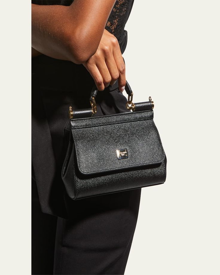 Dolceamp;Gabbana tophandle bag in textured calf leather and fabric    Flat top handle anchored by rings with 2 1/2" drop    Detachable, convertible shoulder strap; 19"  22 1/2" drop    Flap top with double snap closure; engraved logo plaque     Interior, one slip pocket    Approx. 4.3"H x 7.1"W x 2.4"D    Approx. weight 0.65 lb.    "Sicily" is made in Italy High-end Handheld Satchel With Detachable Handle, High-end Bags With Leather Top Handle, Luxury Top Handle Bags With Detachable Handle, High-end Top Handle Bag With Leather Handles, Luxury Bags With Detachable Top Handle, Luxury Top Handle Bag, Luxury Bag With Detachable Top Handle, Designer Satchel With Top Handle And Branded Hardware, Designer Top Handle Satchel With Branded Hardware