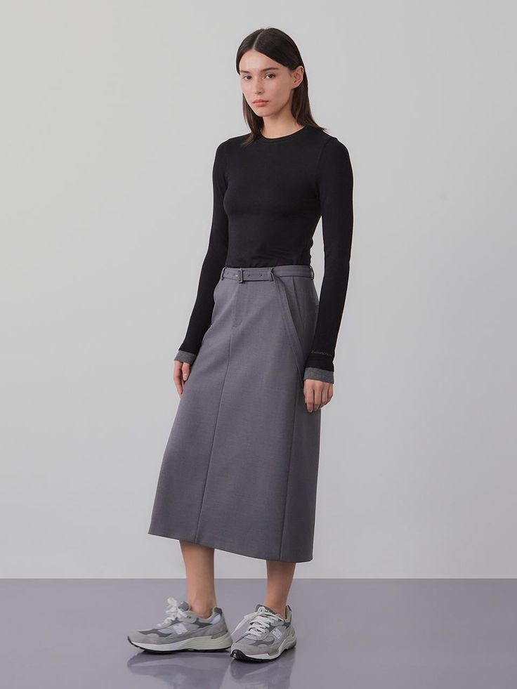 This product is a belted long skirt that exudes sophistication and modern style. The high-waisted design is accentuated with a belt, offering both elegance and a flattering fit. - The skirt features a sleek, straight cut that falls to mid-calf, providing a streamlined silhouette.- A built-in belt cinches at the waist, enhancing the skirt’s tailored appearance.- Made from a smooth, structured fabric, the skirt holds its shape while allowing for ease of movement.- Perfect for professional settings or dressy occasions, this skirt pairs effortlessly with both fitted and loose tops. Chic Denim Skirt With Belt Loops, Workwear Skirt With Belt, Chic Workwear Skirt With Belt, Elegant Relaxed Skirt With Belt, Fall Workwear Skirt With Belt Loops, Elegant Skirt With Belt, Workwear Flared Skirt With Belt Loops, Chic Skirt With Belt Loops For Fall, Chic Mini Skirt With Belt Detail