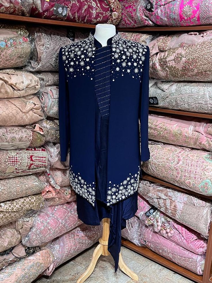 Midnight blue exclusive embellished with intricate pearl, stone, zari and cutdana work, this sherwani speaks volume of class. Commingled with blue color kurta for the complete ensemble. This jacket sherwani is a unique style that we loved. Even the color is fresh and looks royal. Size: 42,44 Occasion: Wedding Ceremony or Reception WASH CARE INSTRUCTIONS - Please Dry clean only when it is applicable. Slight color variation is possible due to digital photography. Ready to Ship! Elegant Sherwani With Pearl Embroidery For Diwali, Bollywood Embellished Sherwani For Party, Blue Nehru Jacket With Dabka For Wedding, Designer Embellished Unstitched Suit With Traditional Drape, Festive Kurta With Pearl Embroidery In Traditional Drape, Embellished Unstitched Sherwani For Eid, Unstitched Pearl Embroidered Sherwani For Eid, Traditional Embellished Sherwani For Wedding, Festive Traditional Drape Kurta With Pearl Embroidery