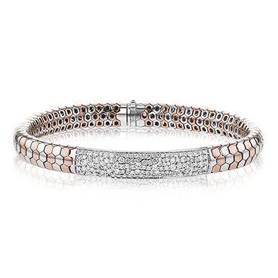 This statement bracelet features an intricate design and is set with a stunning 1.35 ctw of white diamonds. White Diamond Pave Bangle Bracelet, White Diamond Bangle Bracelet With Pave Setting, White Diamond Bracelet With Jubilee Design, Luxury White Diamond Bracelet Hand Set, Luxury White Bracelet With Pave Setting, Fine Jewelry White Bangle With Single Cut Diamonds, White Bangle With Single Cut Diamonds, Timeless White Bracelets With Single Cut Diamonds, Luxury White Pavé Setting Bracelet