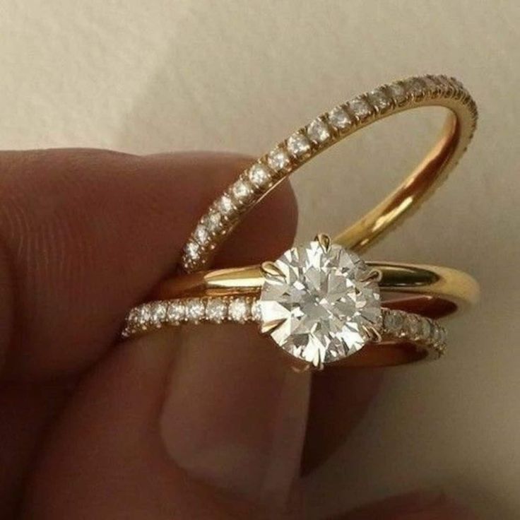 someone is holding their engagement ring in their hand with the diamond set on it's side