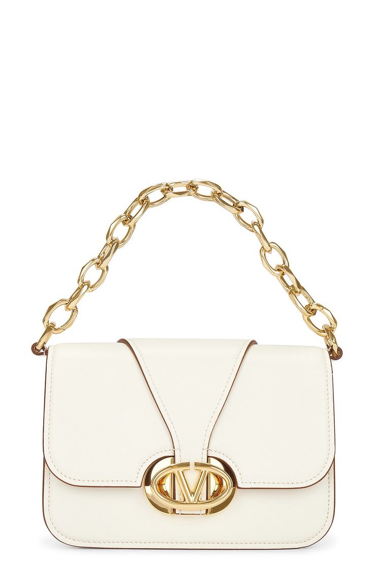 Find VALENTINO Small V Logo O'clock Shoulder Bag on Editorialist. Valentino Garavani Small V Logo O'clock Shoulder Bag in Ivory Leather exterior and interior. Made in Italy. Flap top with magnetic button closure and pivoting gold-tone VLogo hardware. One main compartment. Interior zipper and slip pockets. Detachable gold-tone chain link strap. Detachable and adjustable leather shoulder strap. Measures approx 8.25 W x 6 H x 3.25 D Shoulder strap with a 20 drop Top handle with a 5 drop. VENT-WY1111. 4W0B0N47ZFJ. About the designer: Founded in 1960 by Valentino Garavani and Giancarlo Giammetti, Valentino is one of the world’s most iconic fashion houses. Creative Director Pierpaolo Piccioli’s mission is to capture “the essence of the maison” rather than simply revisit the archive. “Working clo V Logo, Drop Top, Personal Shopper, O Clock, Valentino Garavani, Creative Director, Chain Link, Top Handle, Zipper Pocket