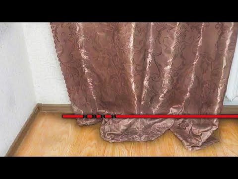 a curtain with red tape on it in front of a window