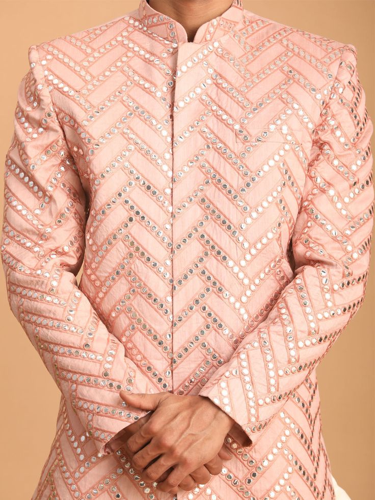 Vastramay Men's Pink Mirror Indo Western Sherwani Top Stand out in style with this stunning pink sherwani top featuring intricate mirror work. It's the perfect blend of tradition and modern design, ideal for festive occasions or special events . Key Features Eye-catching pink color Beautiful mirror work embellishment Mandarin collar for a sophisticated look Full-front button placket for easy wear Long sleeves for a polished finish Specifications Sleeve Length - Long Sleeves Shape - Straight Top Pink Sherwani With Mirror Work For Designer Wear, Bollywood Style Pink Sherwani With Mirror Work, Pink Bollywood Sherwani With Mirror Work, Pink Fitted Bollywood Sherwani, Pink Bandhgala With Zari Work For Eid, Unstitched Pink Bollywood Bandhgala, Pink Sherwani With Mirror Work For Festivals, Pink Bandhgala With Zari Work And Long Sleeves, Pink Bandhgala With Resham Embroidery For Festive Occasions