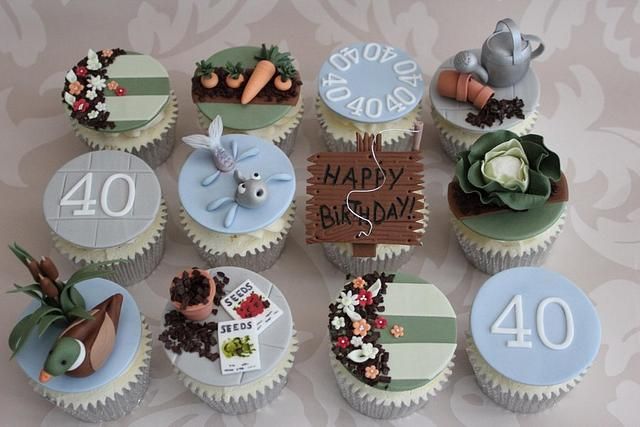 twelve cupcakes decorated with fondant numbers and decorations for a 40 year old birthday