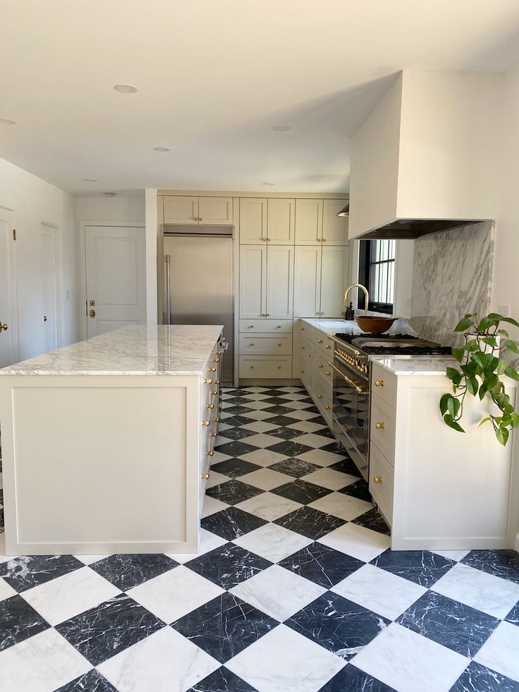 a kitchen with black and white checkered flooring