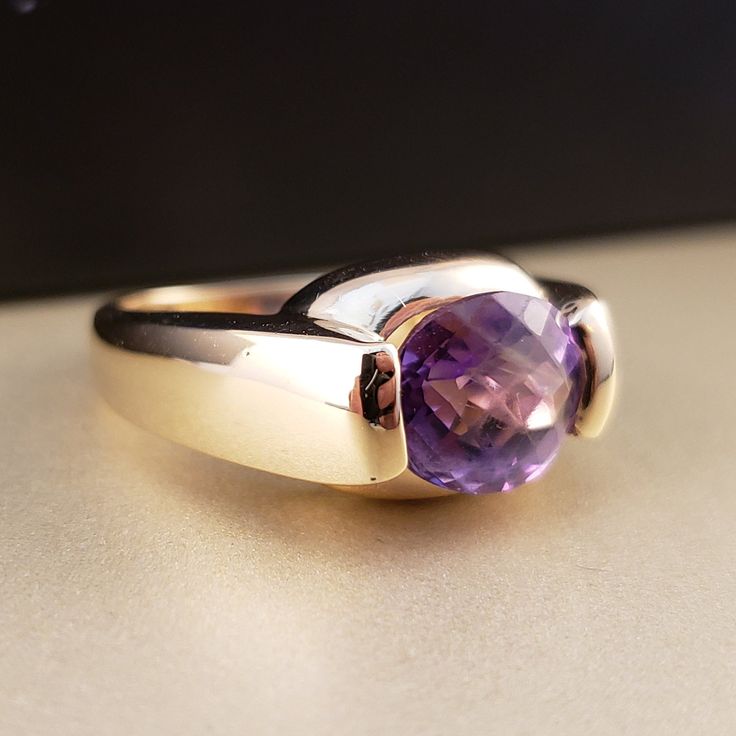 "\"Previously Loved, Not New\" Vintage Amethyst Ring, Featuring a Genuine Amethyst center (*Price of the ring is really gold only. The center is pretty scratched on the surface.*) This Genuine Purple Amethyst center stone is a checkered board cut oval shape. 14k Yellow Gold setting with 2 heavy bars. **Ring size: 6.25 **Amethyst is February's Birthstone, AND 2018 color of the year. This item can be sized up or down 2 sizes for an additional $30.00 Please feel free to contact me anytime, if you h Classic Amethyst Birthstone Ring With Accent Stones, Timeless Amethyst Promise Ring, Timeless Amethyst Gemstone Rings, Formal 14k Gold Amethyst Ring, Timeless Purple Rings Perfect For Gifts, Timeless Purple Rings As Gifts, Timeless Purple Rings For Gifts, Classic Amethyst Round Cut Birthstone Ring, Classic Amethyst Birthstone Ring With Round Cut