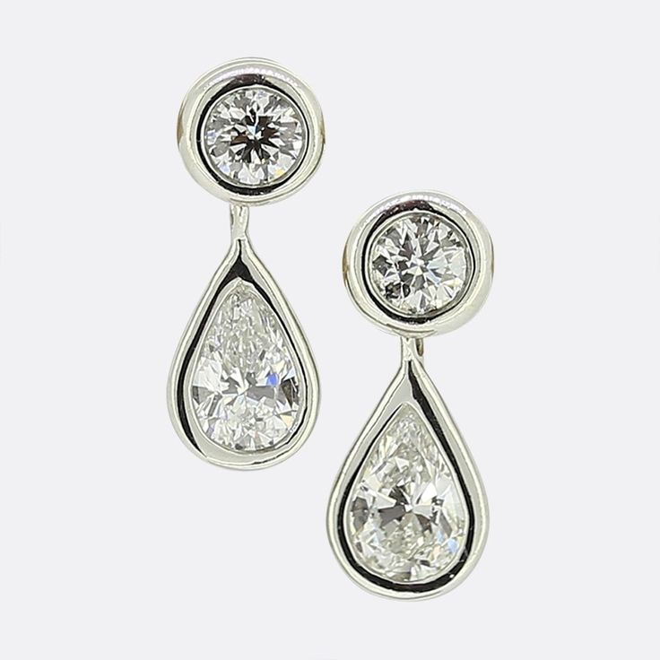 Here we have a delightful pair of diamond drop earrings from the world renowned jewellery designer Tiffany & Co. Each piece has been crafted from platinum and showcases single round brilliant cut diamond with a pear shaped diamond hanging freely below. Condition: Used (Excellent) Weight: 2.4 grams Dimensions: 11mm x 4.5mm Total Diamond Weight: Approx. 0.66 carats (pear: 0.25ct each, round: 0.08ct each) Diamond Details: Colour: F, Clarity: VS Marked: 'T&Co. 'PT950' 'Peretti' Box: Tiffany & Co. Earring Box Tiffany And Co Earrings, Diamonds By The Yard, Tiffany Diamond, Tiffany Earrings, Earring Box, Jewellery Designer, Platinum Engagement Rings, Heart Drop Earrings, Tiffany And Co