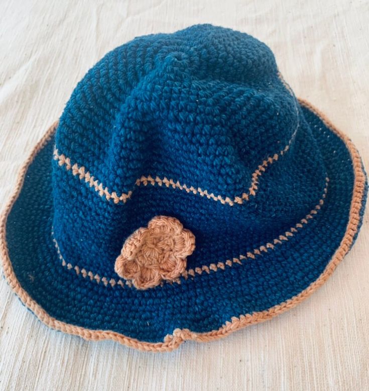 This Thai Cotton hat is made entirely by myself from growing the cotton and indigo to making the pattern and stitching.  I live in the Sakon Nakon province in the North East of Thailand and been selling my products locally for most of my life until I found Etsy to sell worldwide. Please check out my bio to see videos and pictures of how Thai cotton is grown spun and weaved The item is free size so will fit most kids sizes Models head measurement is 11" Custom size available on request. Please allow up to 3-4 working days for item to be sent which will give me enough time to complete the item.  If you have any questions about the item please do ask and I will do my best to answer your questions. Navy Cotton Brimmed Hat, Blue Cotton Wide Brim Hat, Navy Cotton Hat For Spring, Blue Wide-brim Cotton Sun Hat, Blue Cotton Wide Brim Sun Hat, Blue Wide Brim Cotton Sun Hat, Blue Cotton Sun Hat One Size Fits Most, Navy Cotton Hat With Short Brim, Bohemian Cotton Crochet Bucket Hat