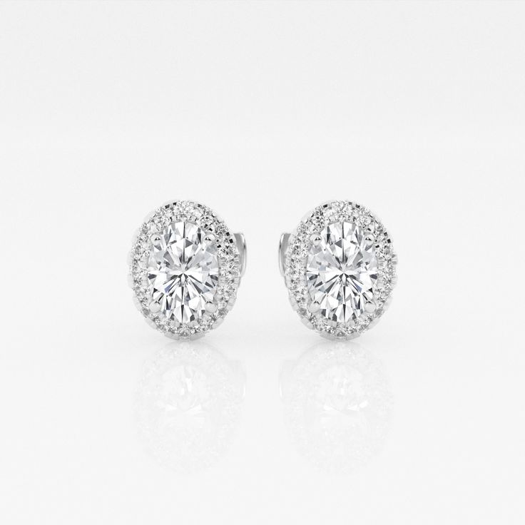 These imperial looking oval stud earrings are one of our best sellers. Large oval cut lab grown diamonds with a halo of round diamonds are a true amalgamation of style and glamor. Timeless Oval Brilliant Cut Earrings, Elegant Oval Diamond Earrings With Halo Setting, Oval Halo Diamond Earrings, Oval Halo Setting Earrings For Formal Occasions, Formal Oval Halo Setting Earrings, Formal Oval Earrings With Halo Setting, Elegant Oval Diamond White Diamond Earrings, Timeless Oval Diamond Earrings For Wedding, Timeless Oval Cubic Zirconia Diamond Earrings