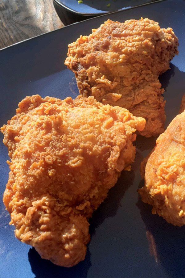 three pieces of fried chicken on a blue plate