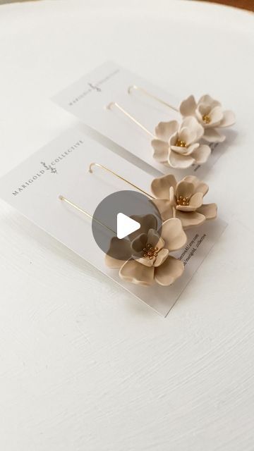 two flower clips sitting on top of a white table