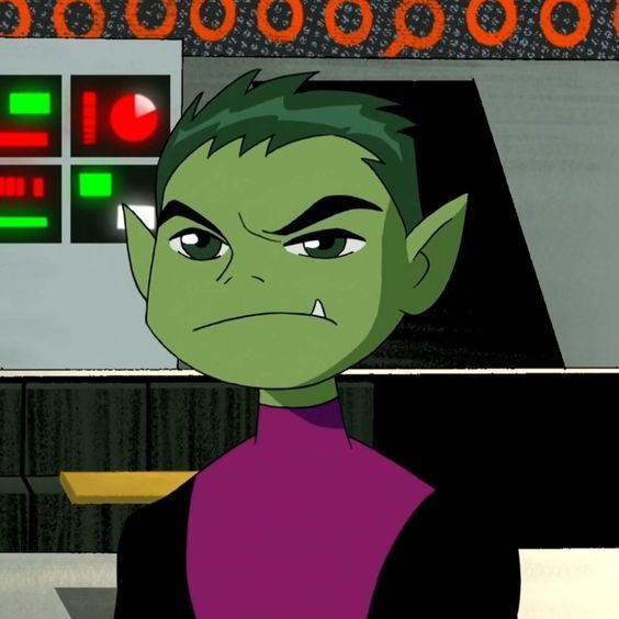 a cartoon character with green hair and purple shirt in front of a computer monitor screen