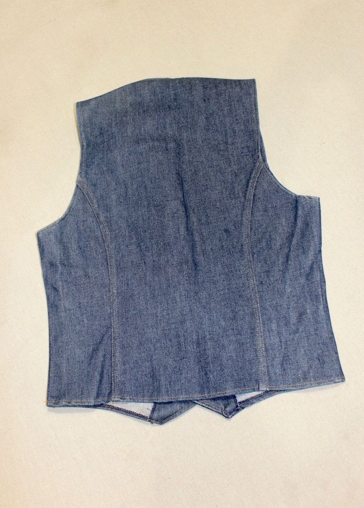 "-ulabeled- Cotton Men's small - medium, not labeled for size (please rely on measurements) 1970's 'New Old Stock' Denim vest, Dark Blue denim with Gold stitching. Similar to a Levi's or Wrangler product. No labels (label removed), possibly a department store product like Penney's or Ward's. These snap covers are pretty common on 'off brand' products. Four (4) copper clap snap, two (2) pocket Two vertical a'arc' seams, one each side, on back. 20\" Chest, underarm to underarm. Overall length: 24\ Fitted Medium Wash Vest With Button Closure, Vintage Cotton Vest With Button Closure, Fitted Dark Wash Cotton Vest, Fitted Cotton Denim Vest With Button Closure, Retro Cotton Vest With Buttons, Retro Cotton Denim Vest With Button Closure, Retro Fitted Denim Vest With Button Closure, Vintage Fitted Denim Vest With Buttons, Fitted Cotton Denim Vest With Pockets