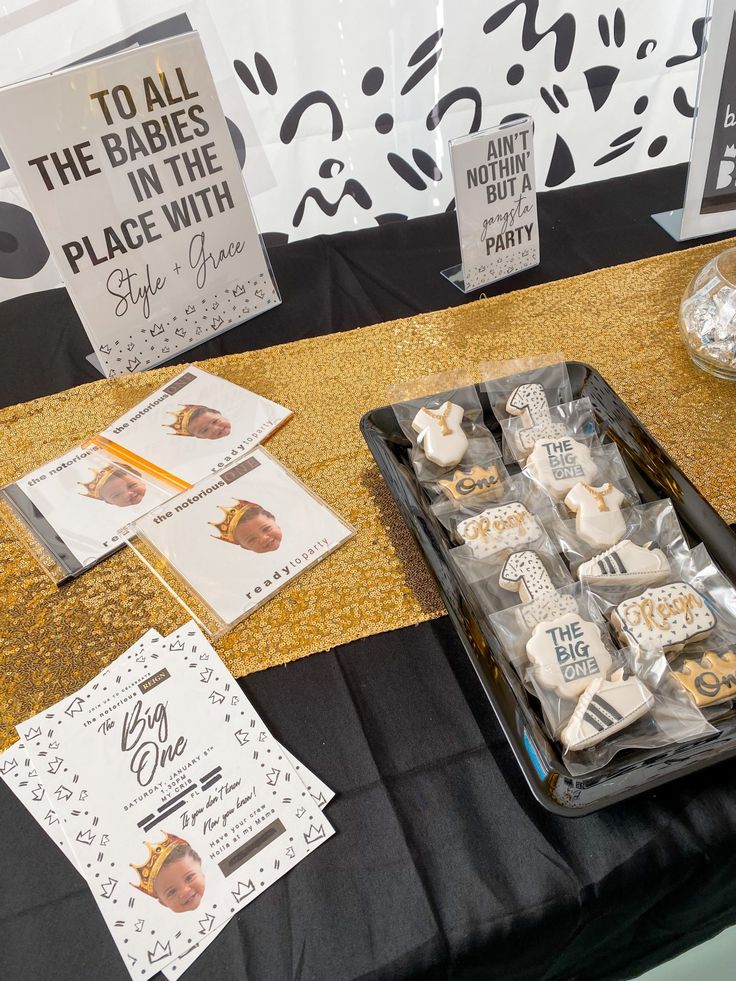 there is a tray of cookies on the table next to some cards and other decorations