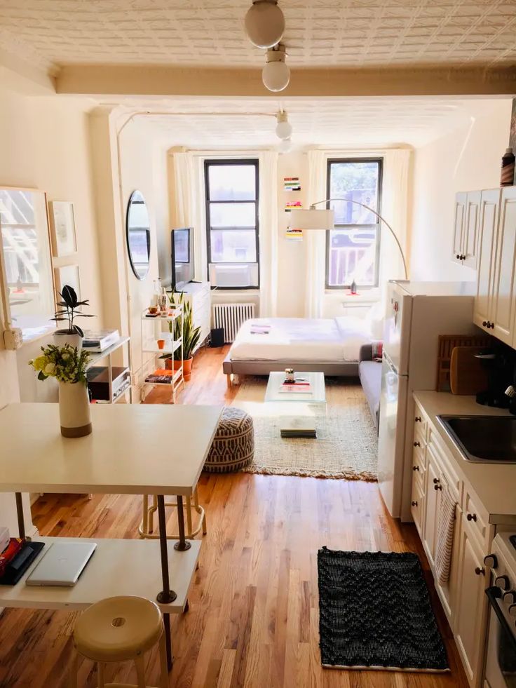 a living room filled with furniture and lots of windows