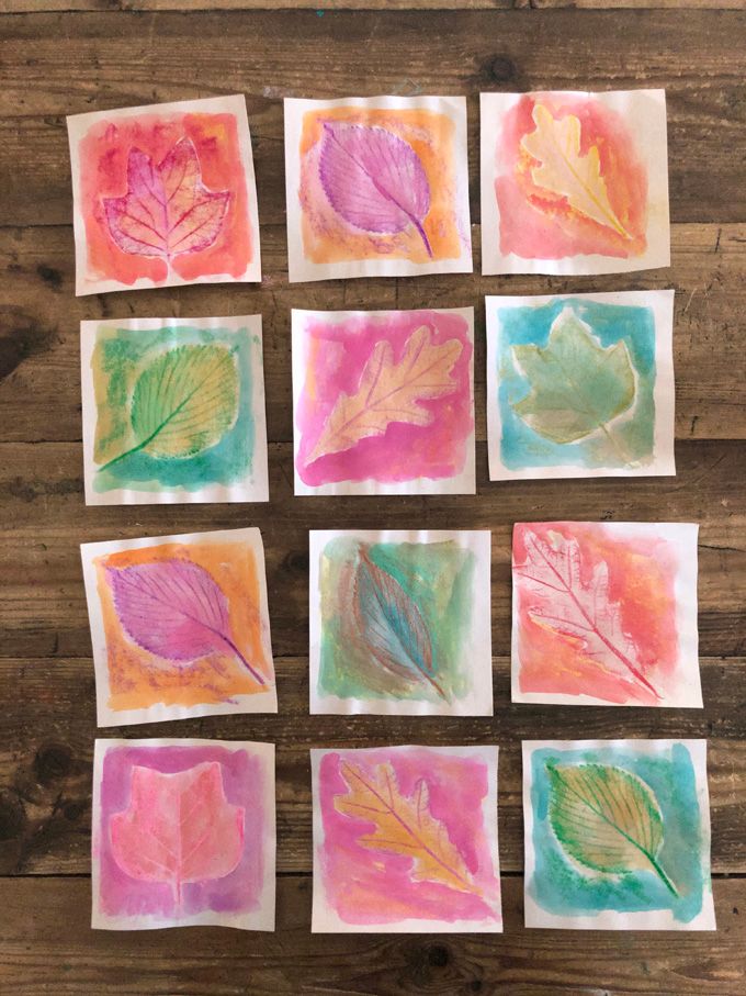 leaf rubbings with crayons and watercolor on wood background, for fall art project