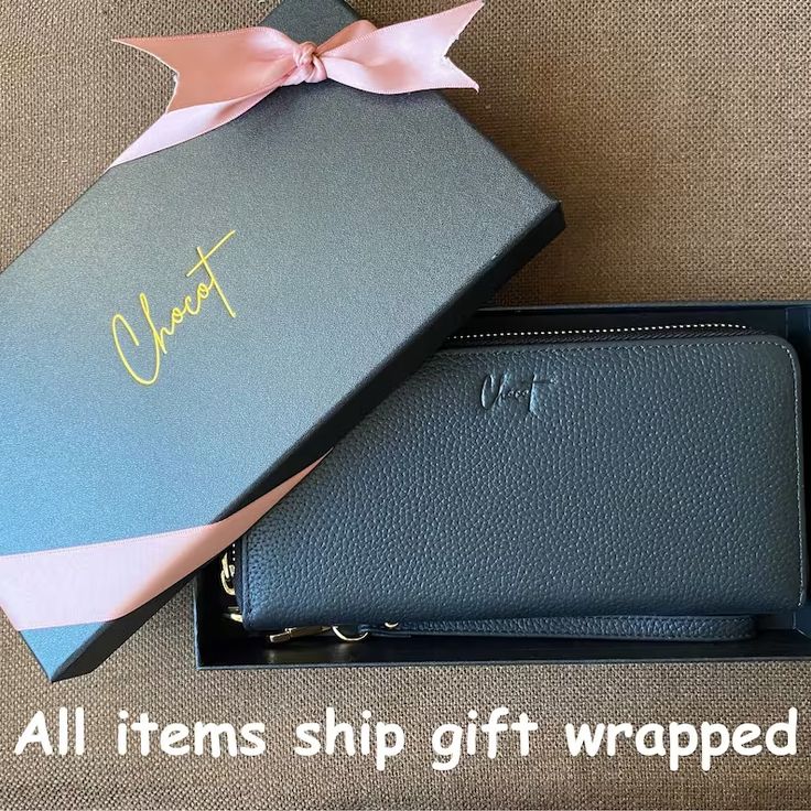 a black wallet with a pink bow on it and the words, all items ship gift wrapped