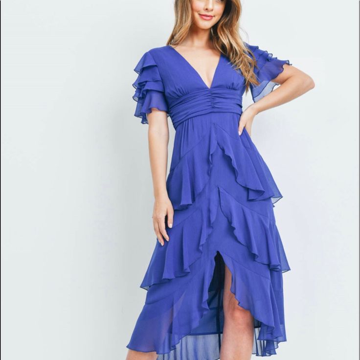 Look No Further Than This Gorgeous Royal, Blue-Colored Ruffle Dress For Women! This Stunning Dress Is Designed With A Feminine Ruffled Silhouette That Is Sure To Turn Heads. Crafted From A Lightweight And Airy Fabric, This Dress Is Perfect. The Vibrant Blue Hue Adds A Splash Of Color To Any Ensemble And The Delicate Ruffles Add A Romantic Touch. The Zipper Provides A Custom Fit, And The Flowy Skirt Creates A Flattering Shape. Whether You’re Attending A Garden Party Or A Day At The Beach, This Co Blue Asymmetrical Hem Dress For Spring, Flowy Blue Chiffon Midi Dress, Blue Chiffon Midi Dress For Brunch, Blue Chiffon Midi Dress With Ruffles, Blue Chiffon Mini Dress With Short Sleeves, Blue Ruffled Midi Dress For Night Out, Blue Chiffon Short Sleeve Mini Dress, Blue Flowy V-neck Midi Dress, Blue Asymmetrical Spring Dress