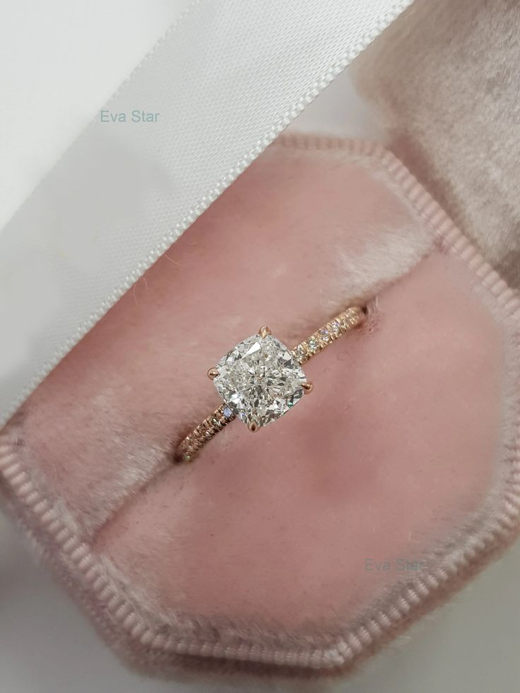 an engagement ring in a pink velvet case with the word go on written across it