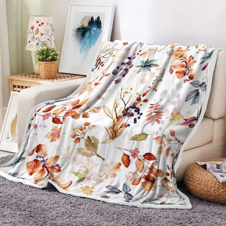 the blanket is covered with flowers and leaves