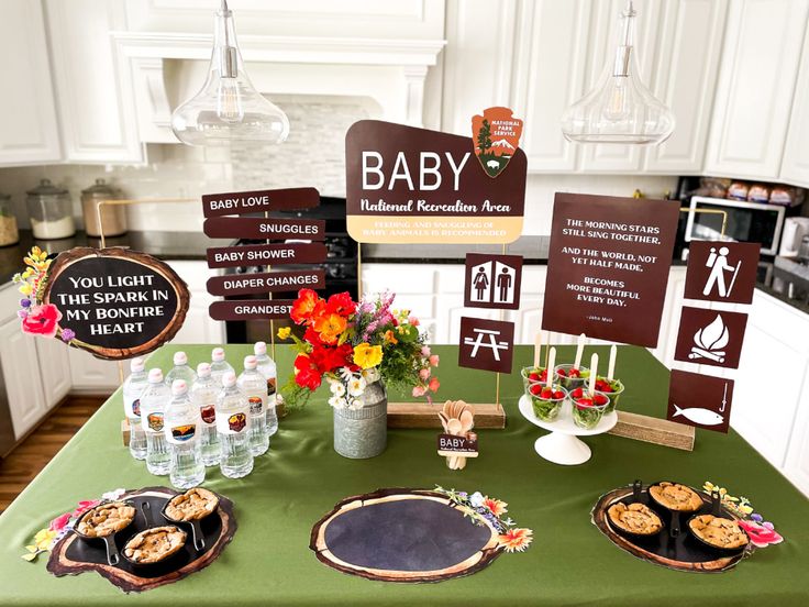 there is a baby shower table set up with food and drinks on the table in front of it