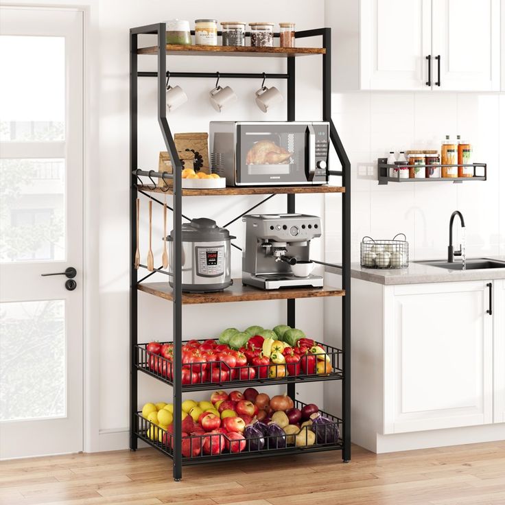 a kitchen filled with lots of food on top of metal shelving units next to a window