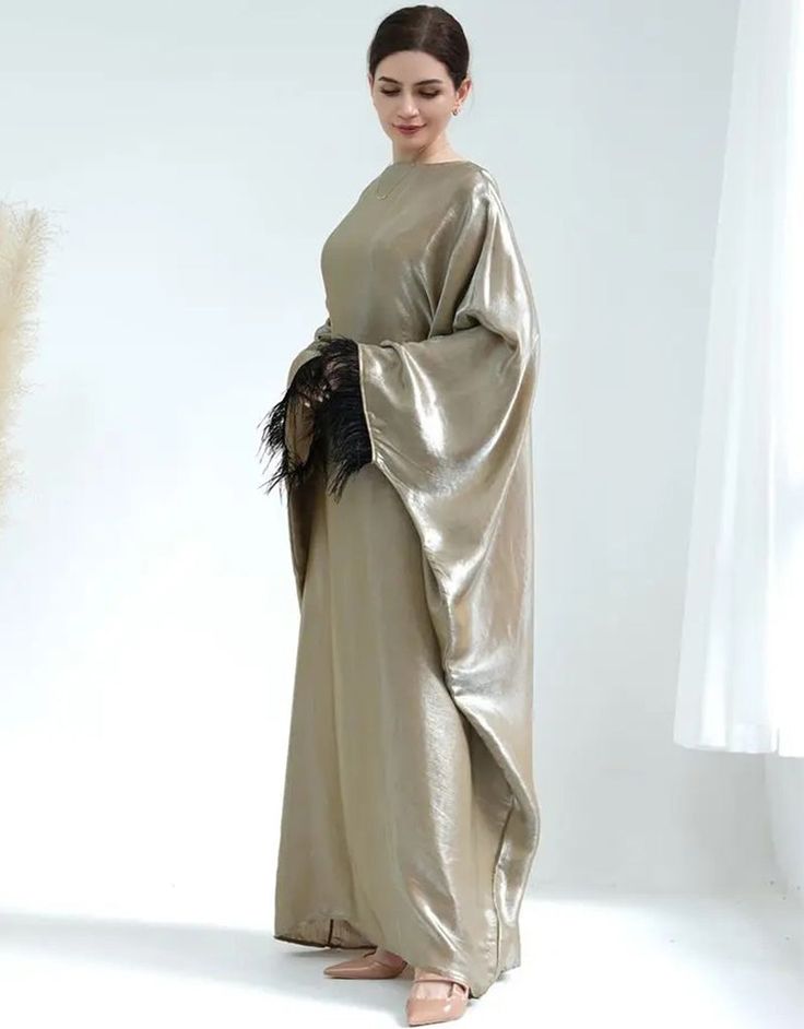 Enchanting Celebration: Feathered Abaya for Traditional Elegance (All Seasons) Celebrate in Style: Embrace the spirit of your cultural festivals with this captivating abaya adorned with delicate feathers. Comfortable All Season: Breathable broadcloth fabric with slight stretch ensures year-round comfort, perfect for layering or wearing on its own. Flattering Fit: The regular fit provides a balanced silhouette for a graceful look. Effortless Maintenance: Machine-washable polyester makes upkeep si Long Khimar For Wedding Eid Festival, Long Khimar For Wedding And Eid, Floor-length Abaya For Festive Parties, Festive Floor-length Abaya For Party, Formal Floor-length Festive Abaya, Formal Festive Floor-length Abaya, Long Khimar For Wedding, Gold Floor-length Thobe For Eid, Elegant Gold Floor-length Thobe