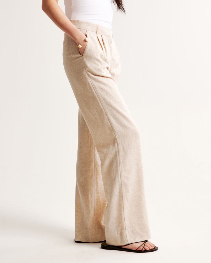 Our signature A&F Sloane Tailored Pant with a low rise, in our breezy linen-blend fabric, that's perfect for dressing up or down. Featuring figure-flattering pleating details, a functional fly and pockets and a partially elasticated waistband for ultimate adjustability. The intended length hits the bottom of a flat shoe. Please reference our size chart to determine your perfect size and inseam! Chic Relaxed Fit Flax Bottoms, Fitted Full-length Linen Pants, Spring Full-length Linen Bottoms, Full Length Linen Bottoms For Loungewear, Chic Flax Bottoms For Loungewear, Chic Flax-colored Loungewear Bottoms, Chic Cotton Bottoms In Flax Color, Flax Wide Leg Relaxed Fit Pants, Effortless Linen Pants For Summer