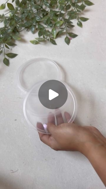 a person is holding a plastic container