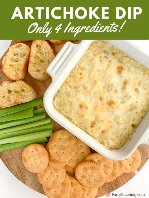 artichoke dip on a plate with crackers and celery next to it