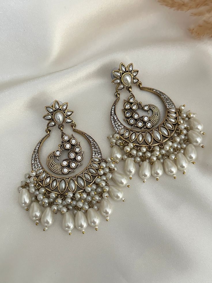 High quality kundan  work classic chandbali with pearl and faux american diamond detailing statement earrings, available in colors.  Lightweight  Dimensions- Earrings length- 3 inches  Style tip- Pair it with any beautiful traditional outfits  and flaunt with Unique style of collection from us. Perfect match for Festival and Traditional wear.  Take Care Tips-  Kee away from perfume, Hair spray and. Moisture.  Store in dry place , Ziplock bag or Airtight box.    Clean with dry cloth.  Jewellery i Diwali Chandbali Earrings With Mirror Work, Festival Chandbali Earrings With Mirror Work, Chandbali Earrings With Mirror Work For Festivals, Festival Chandbali Chandelier Earrings With Mirror Work, Chandbali Chandelier Earrings With Mirror Work For Festivals, Festive Chandbali Chandelier Earrings With Mirror Work, Festival Mirror Work Chandbali Earrings, Chandbali Danglers With Mirror Work For Wedding, Festive Bollywood Chandelier Earrings With Mirror Work