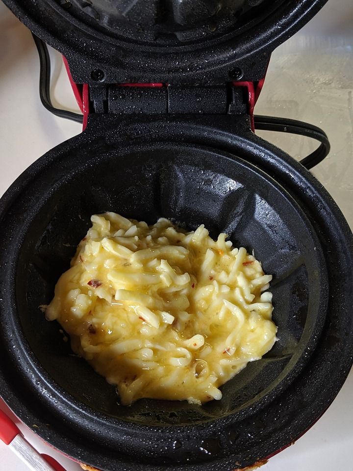 an open waffle maker with some food in it