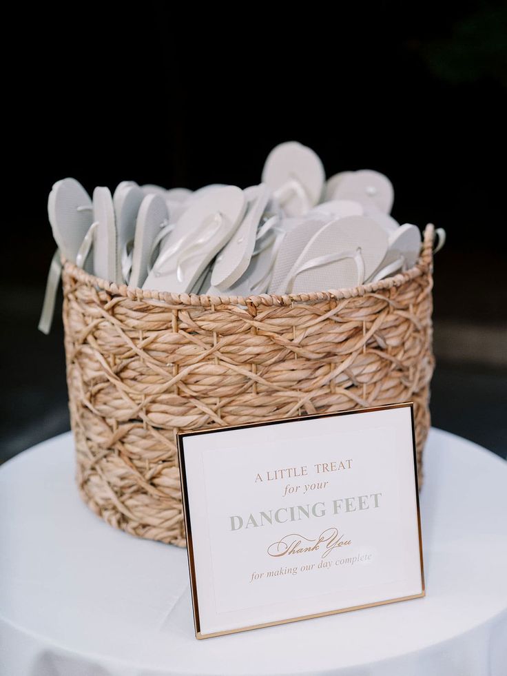 a basket filled with silverware sitting on top of a table next to a sign