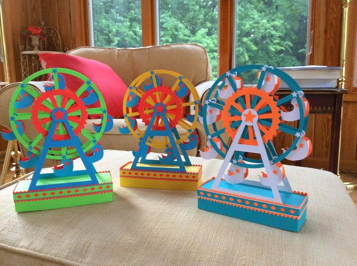 three colorful ferris wheels sitting on top of a table