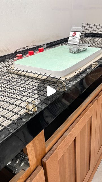 a kitchen counter with a cutting board on it and some red candles in the middle