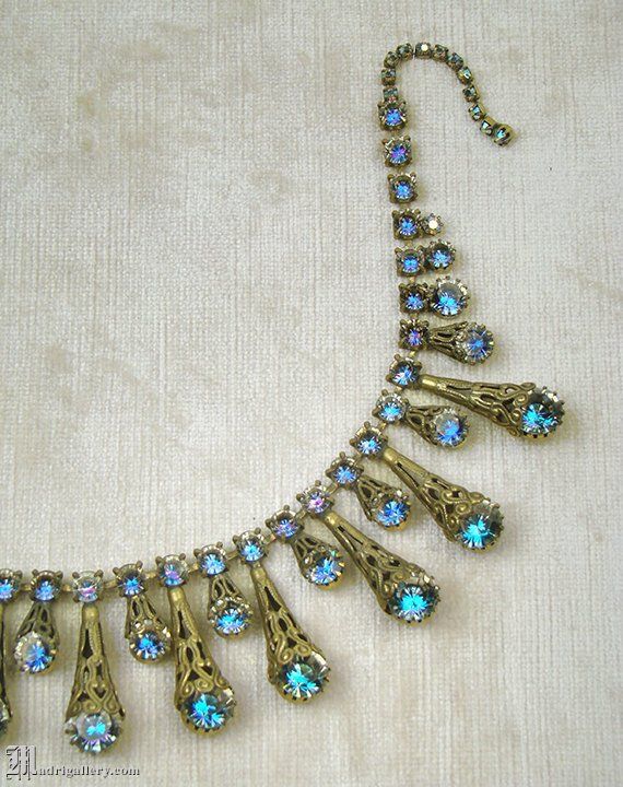 Antique 1930s, conical brass filigree and sapphire blue faceted glass stones, ornate bib, rare quali Vintage Blue Necklace For Evening, Antique Necklaces With Intricate Design For Party, Blue Antique Jewelry With Antique Finish, Vintage Blue Filigree Jewelry, Vintage Blue Jeweled Necklaces, Vintage Party Jewelry With Intricate Design, Blue Art Deco Jewelry For Party, Vintage Blue Jewelry For Party, Vintage Blue Jewelry For Evening