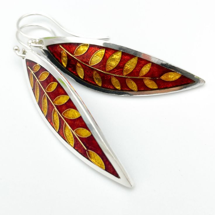 "Ruby Red and GOLD Laurel Leaf Earrings - Cloisonné and Champlevé Enamels on Fine Silver 24k Gold Wires w Sterling Ear Wires by Sandra McEwen Materials: Champlevé & cloisonné Enamels on Fine silver. Earrings Size: 2\" long x .5\" wide Did you know that enamels are melted glass? Yes! It's true... To create this lovely pair of earrings, I first fabricated the silver base out of sheets of fine silver. The lines of the design are actually fine silver wires that I meticulously bent by hand (and t Laurel Leaf, Star Ruby, Love Craft, Enamels, Enamel Earrings, Gold Wire, Enamel Jewelry, Leaf Earrings, Red And Gold