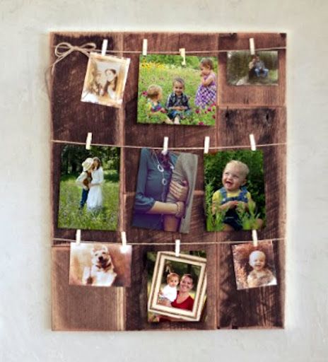 a wooden frame with pictures hanging on clothes pins and photos pinned to the pegs