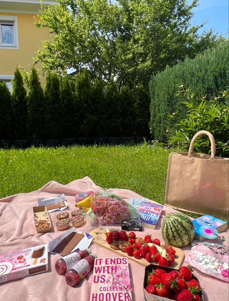 a picnic with strawberries, watermelon and other snacks