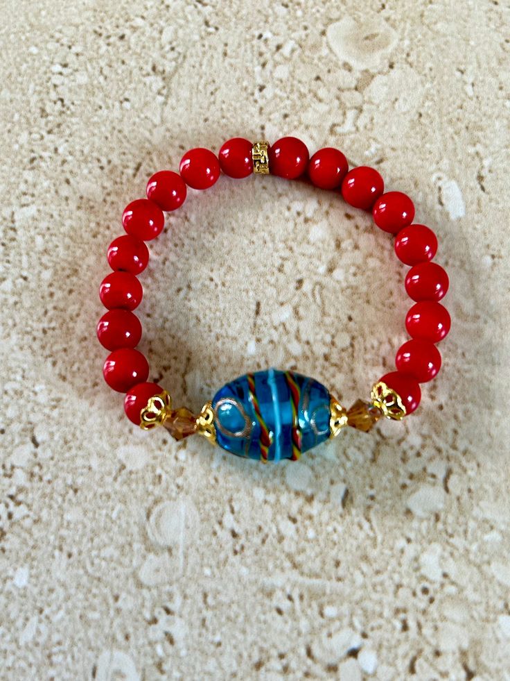 Venetian Glass Bracelet featuring a beautiful Venetian glass focal bead in tones of red and aqua accented with 6mm Topaz A/B Swarovski crystals and 8mm smooth red bamboo coral stones.  Beautiful stacking bracelet.  Measures approximately 7 1/4 inches.  Handmade. GIFT BOXED Red And Aqua, Red Bamboo, Bamboo Coral, Hippie Bracelets, Coral Stone, Handcrafted Artisan Jewelry, Bracelet Ideas, Glass Bracelet, Bracelet Beaded